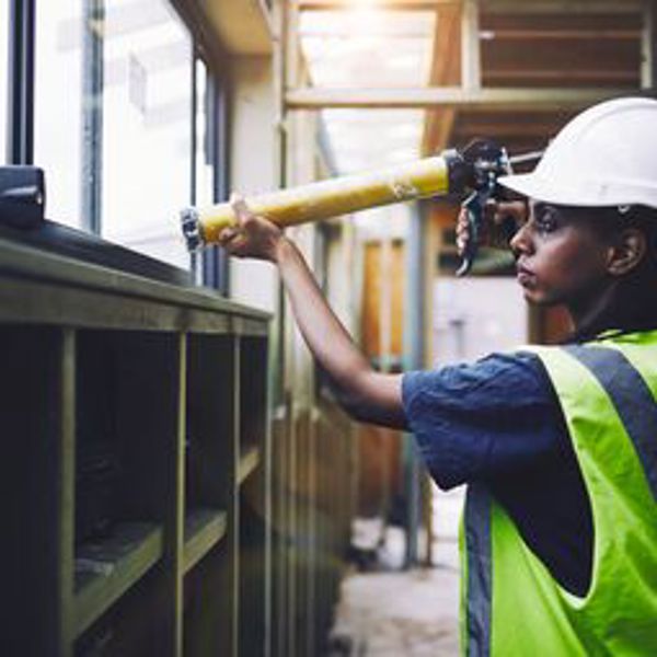 Applying silicone sealant on a construction site